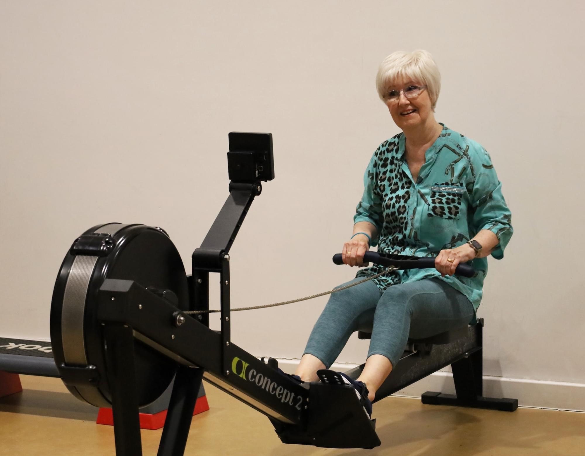 Older member using rowing machine